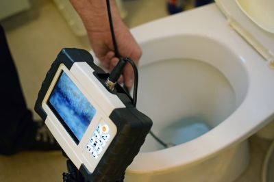 Inspecting a toilet for blockage and damage